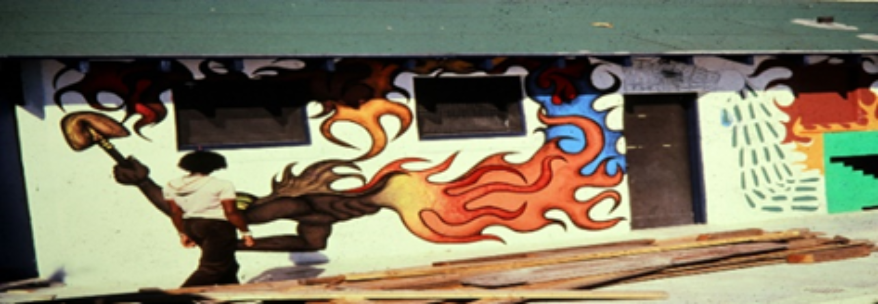 A close-up of a wall with a painting of a person with flames

Description automatically generated